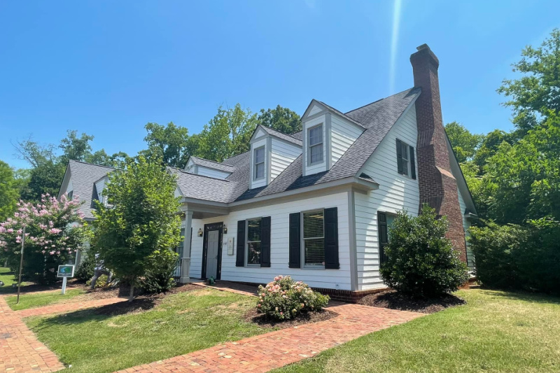 Charlotte-area home with freshly repaired and painted white siding and trim by SouthEnd Painting