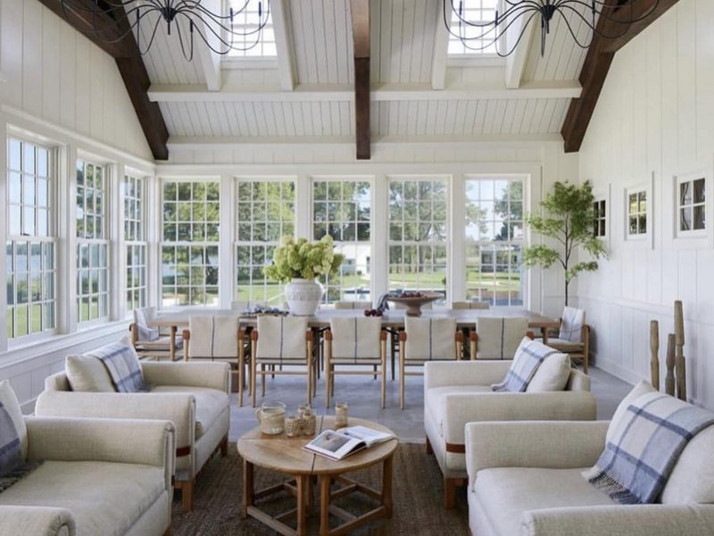 Remodeled white sunroom with beamed ceiling
